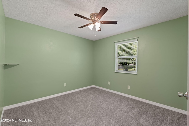 carpeted empty room featuring ceiling fan and a textured ceiling