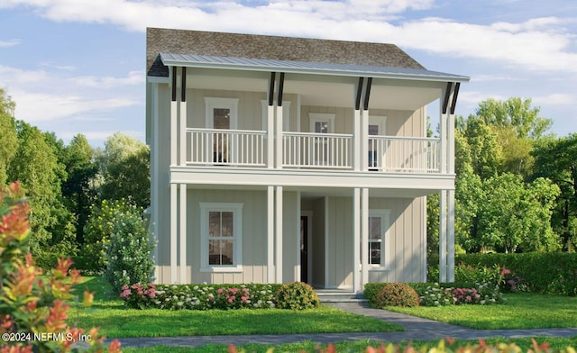 view of front of home with a balcony and a front lawn