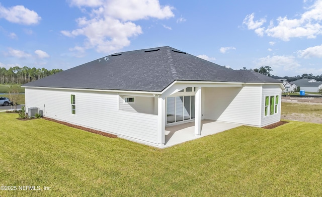 back of house with central AC, a patio area, and a lawn