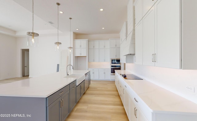 kitchen with pendant lighting, a large island, and sink