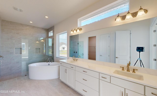 bathroom with tile patterned floors, vanity, and independent shower and bath