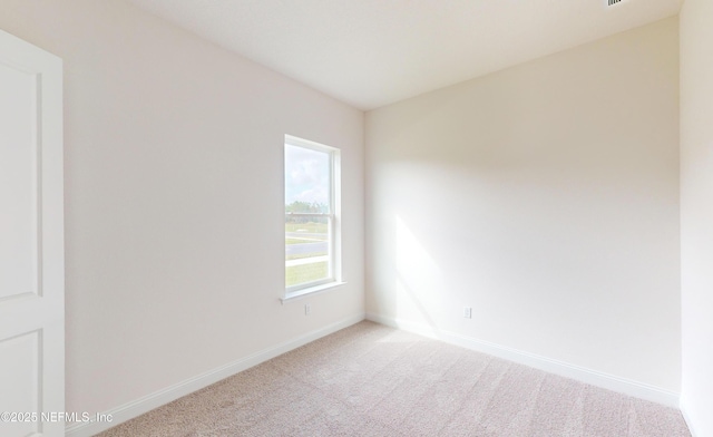 unfurnished room featuring light colored carpet