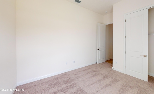 unfurnished bedroom with light colored carpet