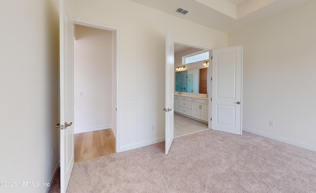 unfurnished bedroom with light carpet