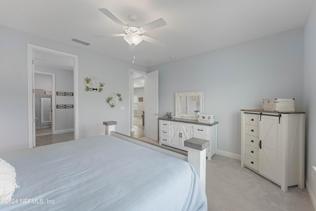 bedroom featuring light carpet, baseboards, visible vents, and a ceiling fan