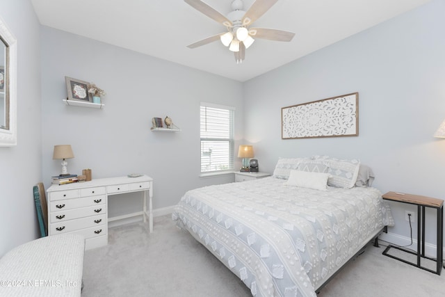 bedroom featuring light carpet, ceiling fan, and baseboards