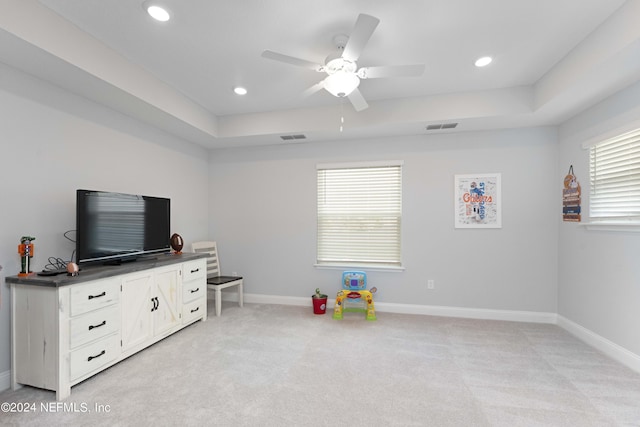 game room with baseboards, visible vents, a raised ceiling, and light colored carpet