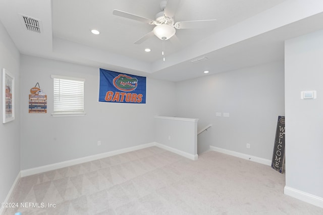 unfurnished room featuring baseboards, a raised ceiling, visible vents, and light colored carpet