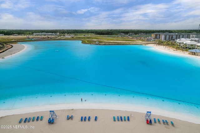 aerial view with a water view and a view of the beach