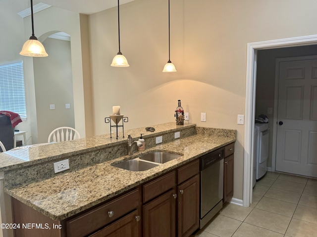 kitchen featuring dishwasher, light stone countertops, sink, and decorative light fixtures