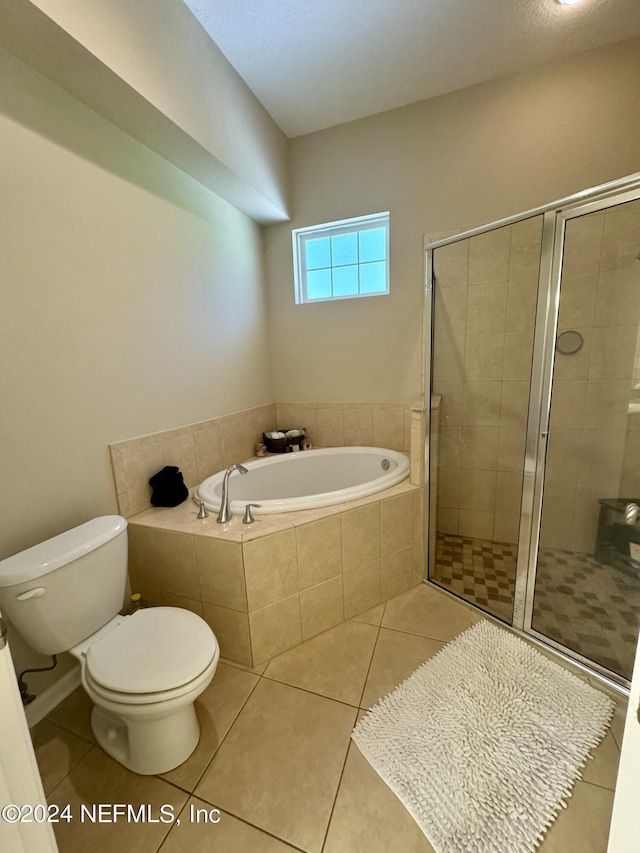 bathroom featuring shower with separate bathtub, toilet, and tile patterned floors