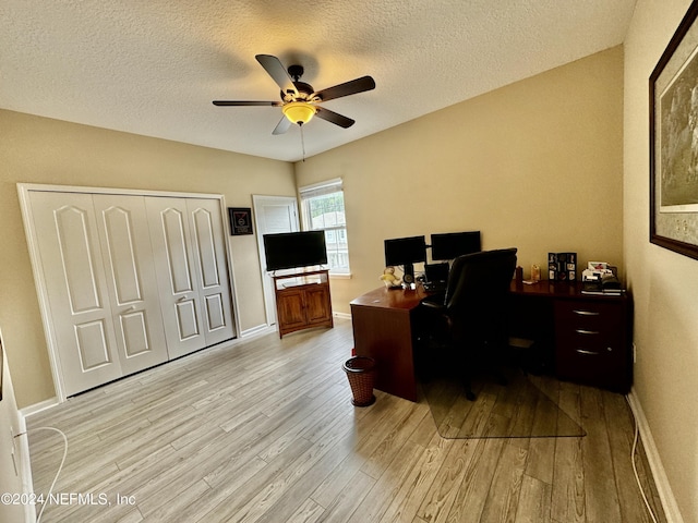 office space featuring ceiling fan, a textured ceiling, and light wood-type flooring