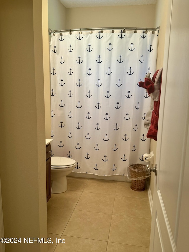 bathroom with tile patterned floors, vanity, and toilet