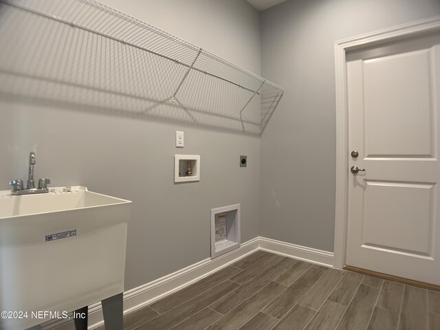 washroom featuring sink, hookup for an electric dryer, dark wood-type flooring, and washer hookup