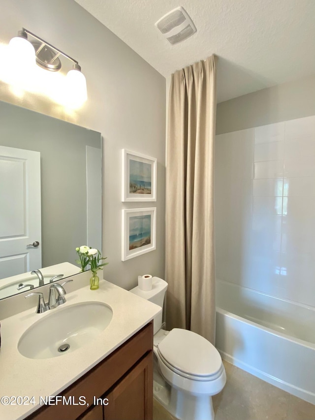 full bathroom with vanity, shower / tub combo, a textured ceiling, and toilet