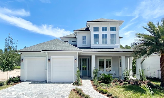 view of front of house featuring a porch and a garage