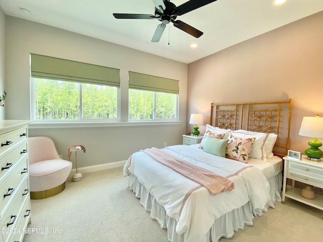 bedroom featuring light carpet and ceiling fan