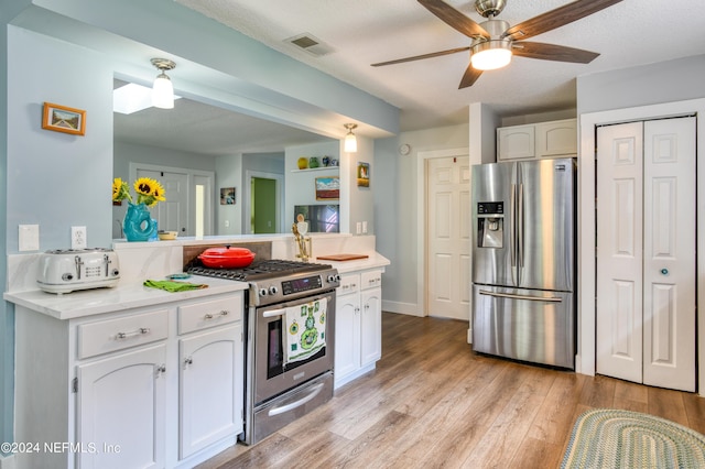 kitchen with ceiling fan, light wood-type flooring, white cabinetry, and appliances with stainless steel finishes