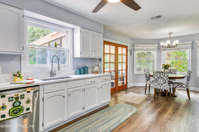 kitchen with dishwasher, white cabinets, a wealth of natural light, and sink