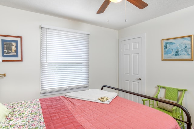 bedroom featuring a textured ceiling and ceiling fan