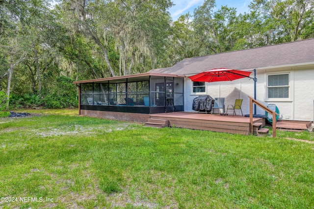 back of house featuring a sunroom, a yard, and a deck