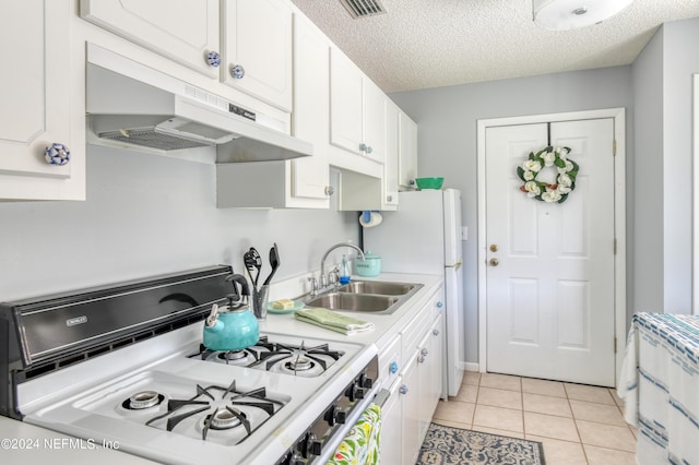 kitchen with white cabinetry, sink, light tile patterned floors, and range with gas cooktop