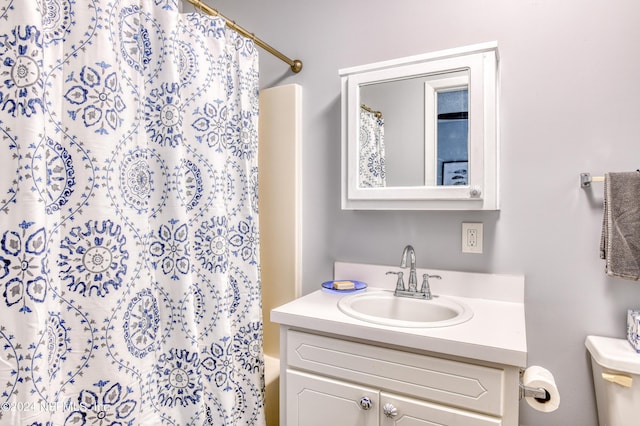 full bathroom with vanity, shower / bath combination with curtain, and toilet