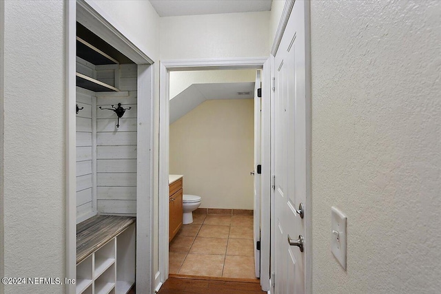 interior space featuring tile patterned flooring, vanity, and toilet