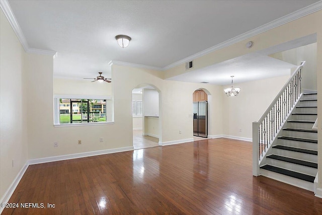 unfurnished living room with ceiling fan with notable chandelier, wood-type flooring, and ornamental molding