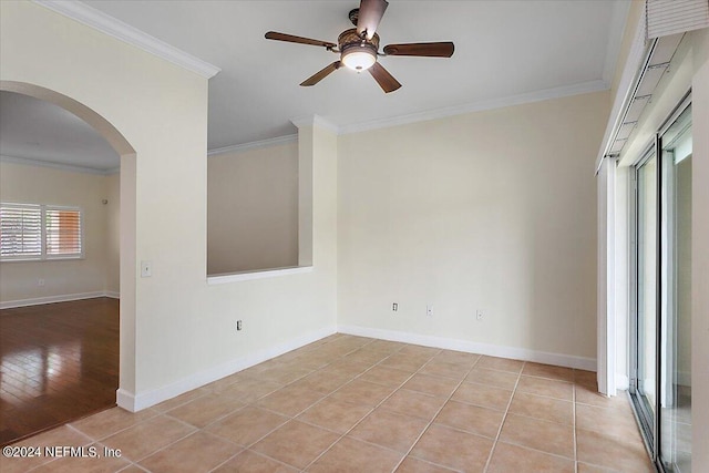 tiled empty room featuring ornamental molding and ceiling fan