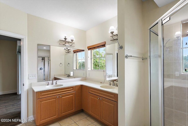 bathroom with tile patterned flooring, vanity, and a shower with door