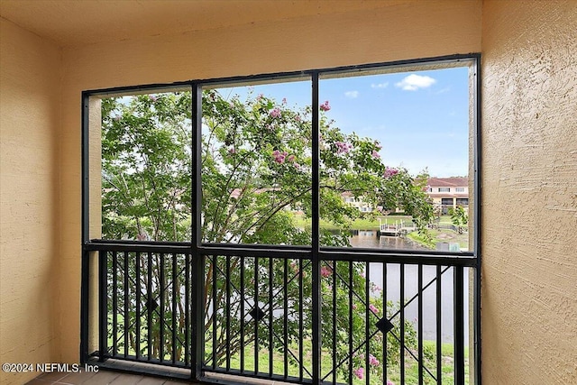 unfurnished sunroom with a water view