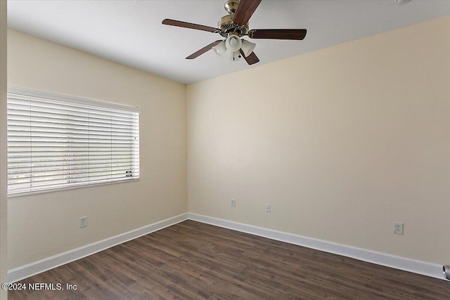 empty room featuring dark hardwood / wood-style flooring and ceiling fan