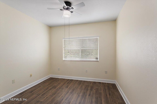 empty room featuring dark wood-type flooring and ceiling fan