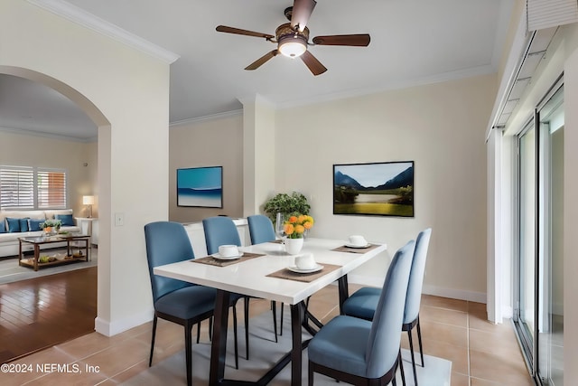 tiled dining space featuring crown molding and ceiling fan