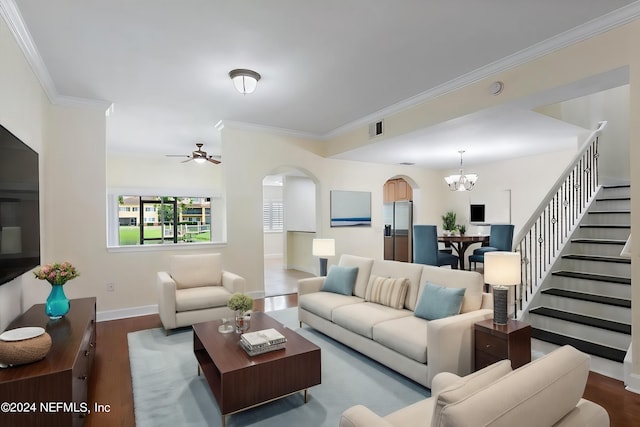 living room featuring ornamental molding, dark hardwood / wood-style flooring, and ceiling fan with notable chandelier