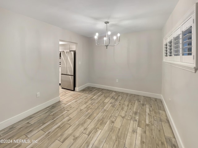6300 A1A S Unit A74D, Saint Augustine, FL 32080 - unfurnished room with a chandelier and light wood finished floors