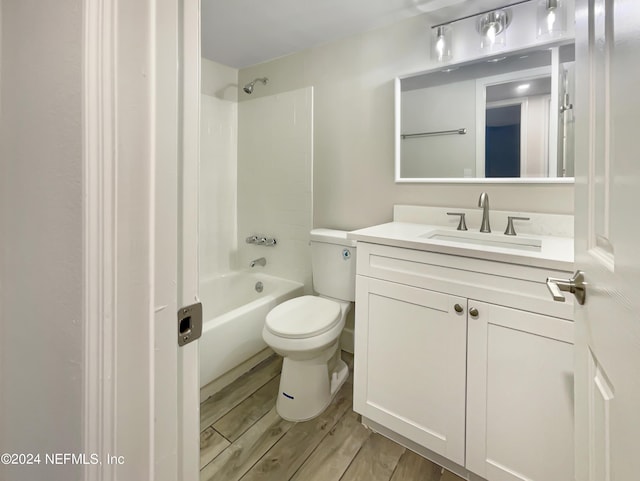 full bathroom with shower / tub combination, vanity, hardwood / wood-style flooring, and toilet