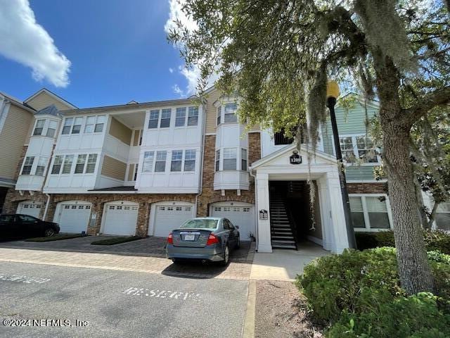 townhome / multi-family property featuring a garage and driveway