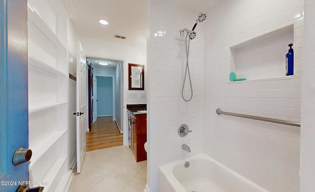 bathroom featuring tile patterned floors, vanity, and tiled shower / bath combo