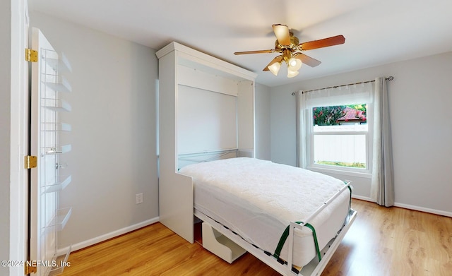 bedroom with light hardwood / wood-style flooring and ceiling fan