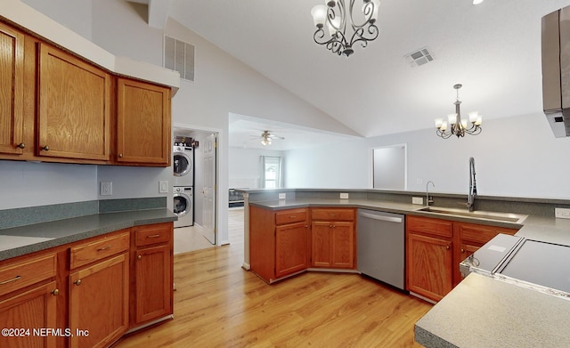 kitchen with pendant lighting, sink, stacked washer / dryer, stainless steel dishwasher, and light wood-type flooring