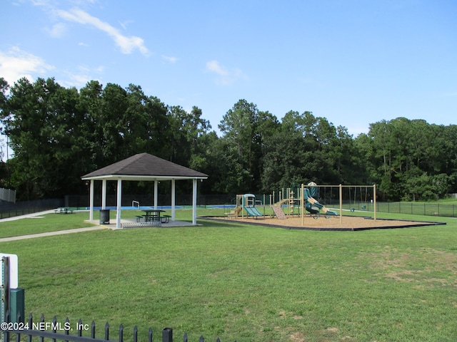 view of community featuring a gazebo, a playground, and a lawn