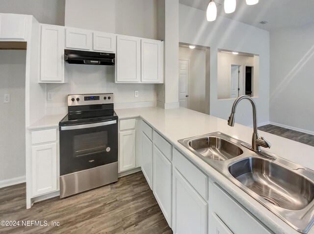 kitchen with range hood, hardwood / wood-style flooring, white cabinets, and stainless steel electric range oven