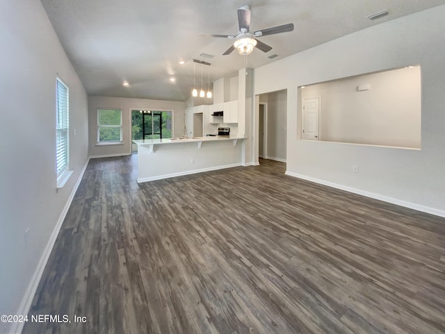 unfurnished living room featuring ceiling fan, dark wood-type flooring, and vaulted ceiling