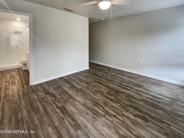 spare room with dark wood-type flooring and ceiling fan