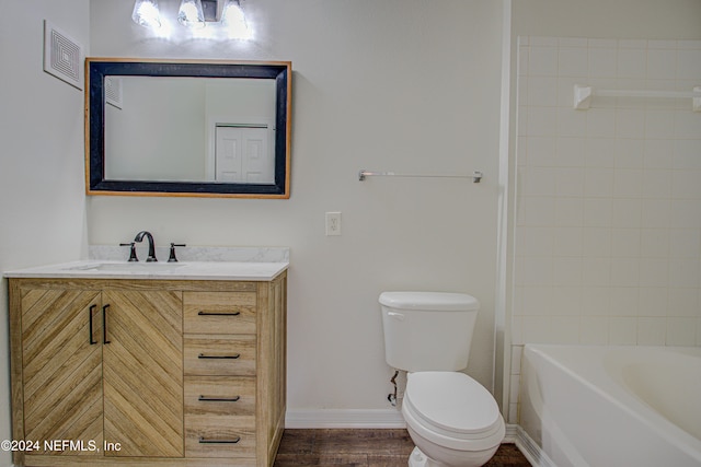 bathroom with wood-type flooring, vanity, and toilet