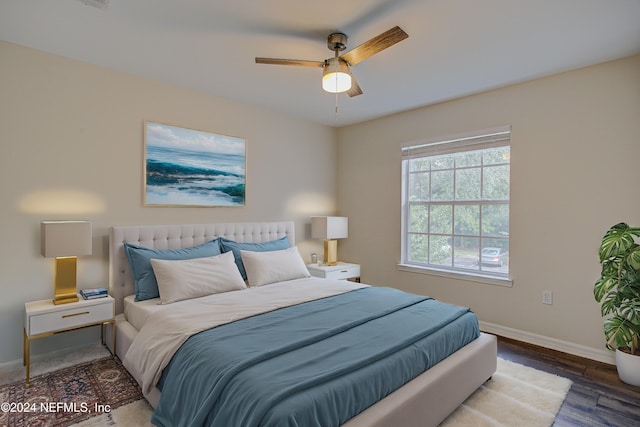 bedroom with ceiling fan and dark wood-type flooring