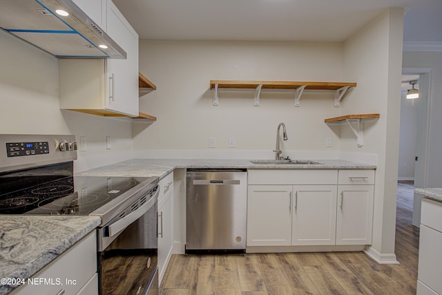 kitchen featuring white cabinets, sink, stainless steel appliances, and exhaust hood