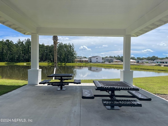 view of patio with a water view